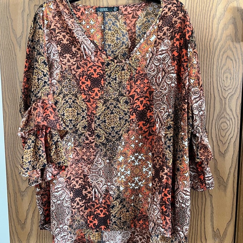 Plus size woman’s stylish blouse with bell sleeves